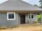 A NEWLY BUILT HOUSE, WITH UNCOMPLETED BUILDING WITH GARDEN